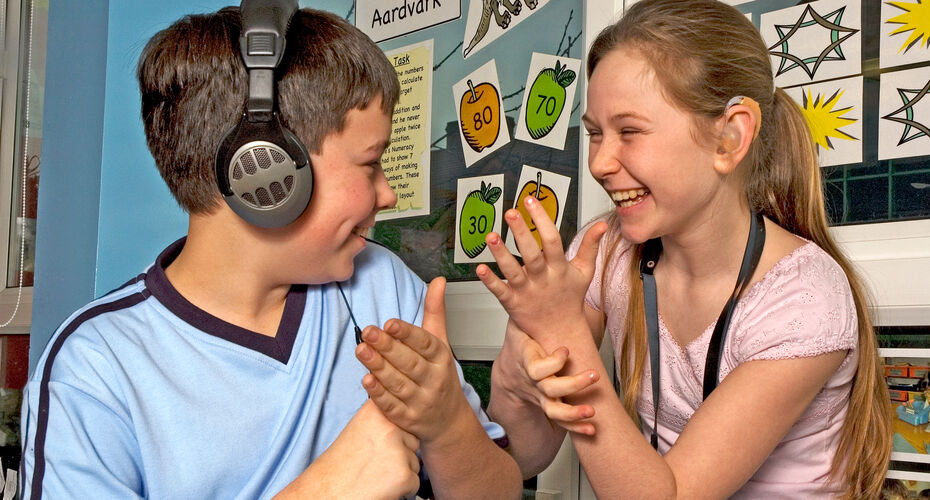 Girl and Boy in headphones playing with hands